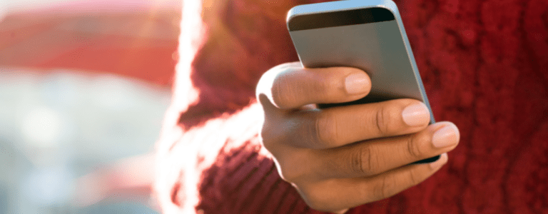 Close up shot of man holding phone